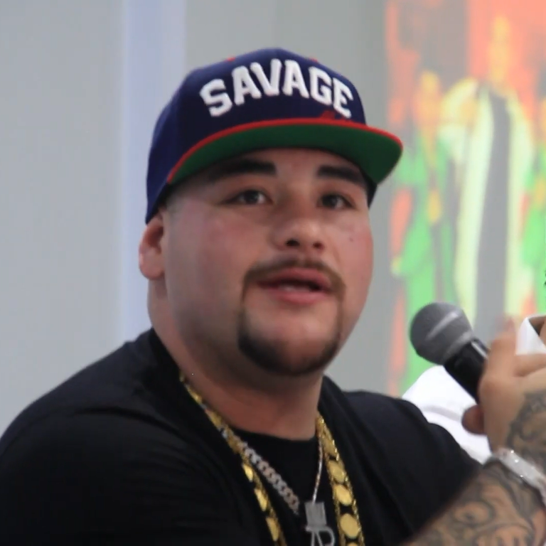 Andy Ruiz Jr. speaking into a microphone at a public event